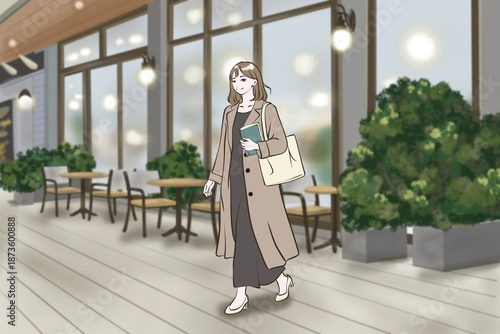 カフェ前を本を持って歩く女性