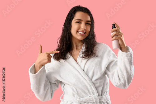 Young woman in bathrobe poi...