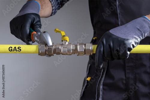 Technician repairing gas pipeline in the house.