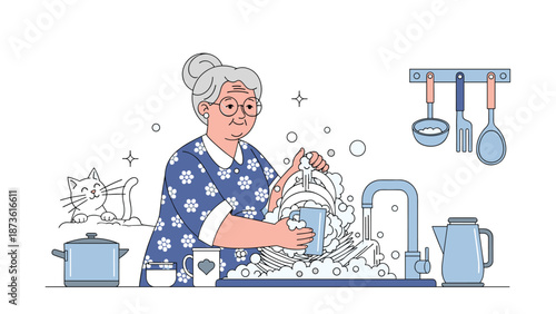 Hardworking senior woman with glasses and an apron washing dishes in a kitchen sink full of soap bubbles with her pet cat.