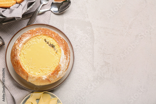 Cheese soup in bread bowl w...