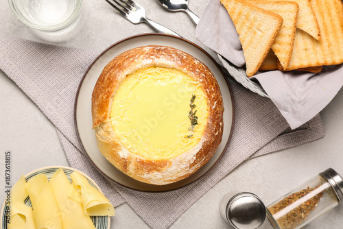 Cheese soup in bread bowl w...