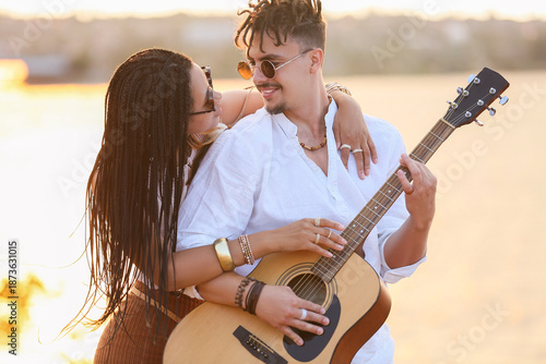 Young couple of hippies wit...