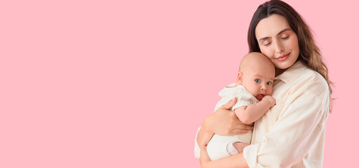 Happy mother with her little baby on pink background. IVF concept