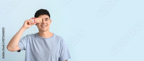 Asian man with credit card ...