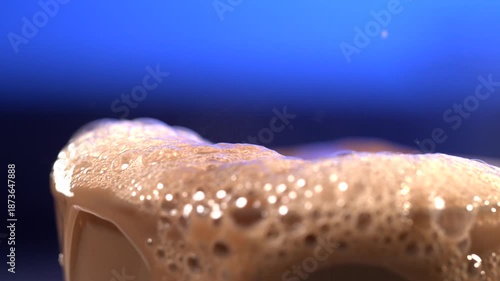 Super slow motion Lush cocoa froth overflows edge, Indulgent chocolate froth exuberantly spills over rim