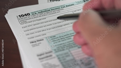 Person is completing the 1040 form for individual income taxes for the year 2025. The document shows personal and financial information required for filing taxes.