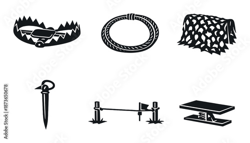 Monochrome set of hunting and trapping tools on dark background