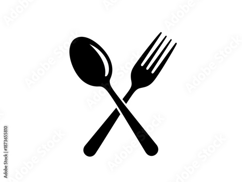 Black spoon and fork crossed on a for dining setup