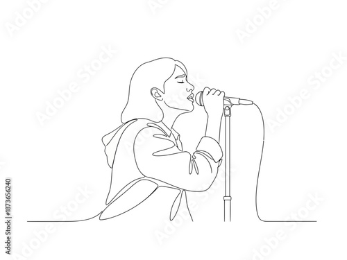 Woman singing into a vintage microphone during a live performance