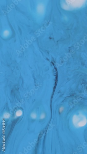 Vertical video. Ink splatter. Drip texture. Defocused blue white colorful water chemical splash black stains spreading on abstract background.