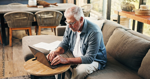 Fotografie Old man, reading and typing on sofa with laptop for asset management, retirement fund and prepare will