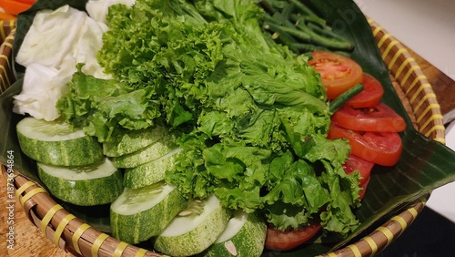 Traditional Indonesian Fresh Vegetable Platter Served on Bamboo Tray