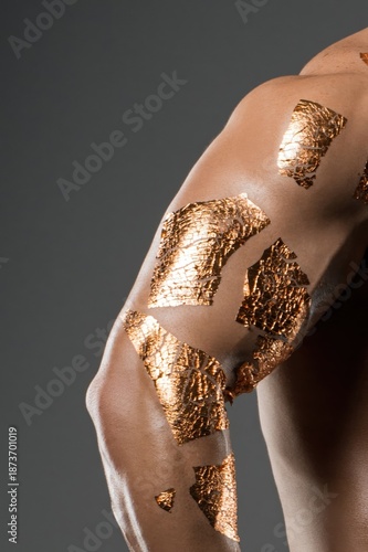 Wallpaper Mural Close-up view of upper arm and shoulder with applied shiny gold leaf for fashion or art concept Torontodigital.ca
