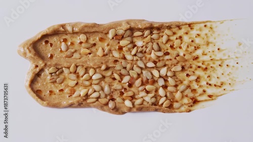 Splotch of spread with seeds on white background