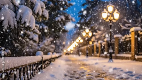 Magical winter evening with falling snow illuminating a park path by ornate lampposts.