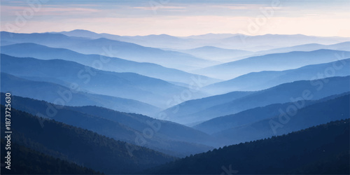 Misty mountain landscape view at sunrise with clouds and morning light