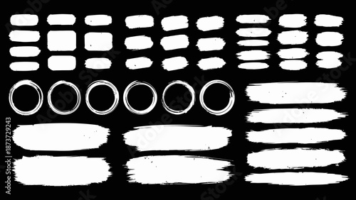 Collection of various white brush strokes shapes and scribbles on a black background