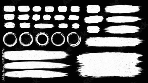 Abstract collection of white brush strokes splatters and oval shapes on a black background
