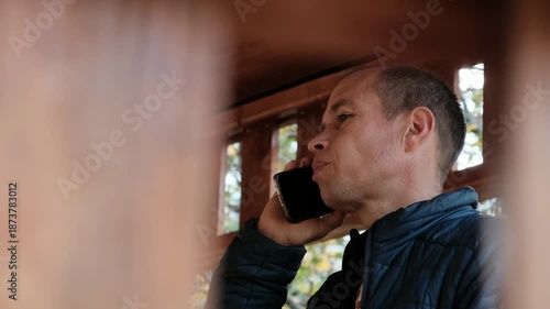 A close-up capturing a man deeply engaged in a serious phone call.