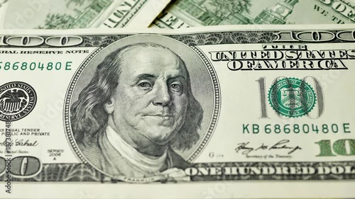 Detailed close up of 100 dollar bill, highlighting Benjamin Franklins portrait. Paper money defined by government regulations. Legal tender for settling national and international debts