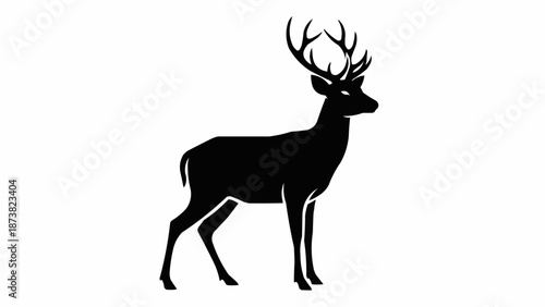 Silhouette of a majestic stag with large antlers standing alert.