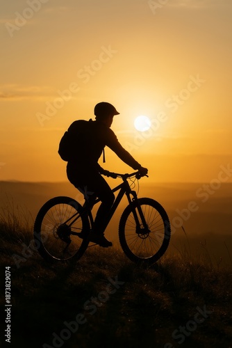 Silhouette of cyclist against sunset sky. Vertical composition showcases outdoor adventure. Perfect for travel and fitness themes. Inspiring image captures freedom and exploration.