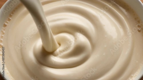 Wallpaper Mural Close-up of thick creamy liquid being poured into a bowl creating dense luxurious ripples and swirls on the surface. Torontodigital.ca