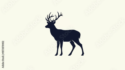 Silhouette of a majestic stag with large antlers standing against a plain background.