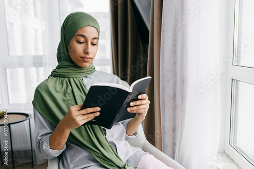 Canvas Print Indoor portrait of smart intelligent Arabic asian petty woman wearing green scar