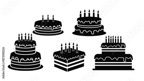 Various tiered cakes with burning candles in a black silhouette