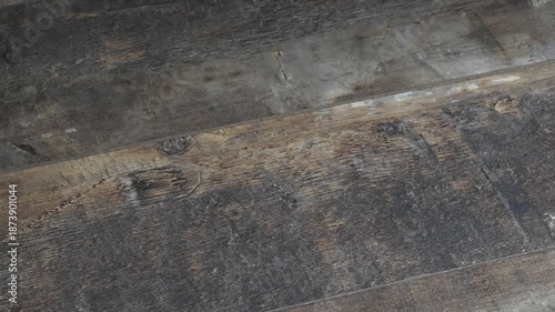 Picking up women's gloves from a wooden table in a simple setting