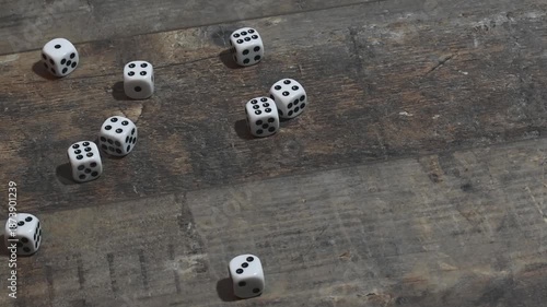 Mass of dice thrown on wooden table during game session