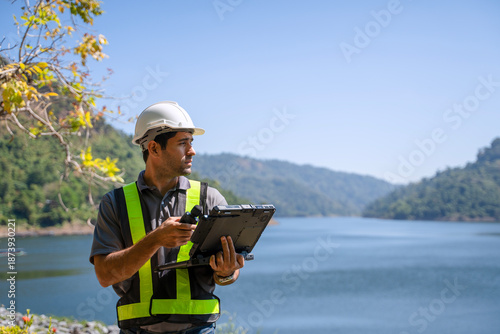 Blue collar worker is working at the dam.