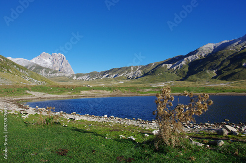 The peak of Monte Corno rises skyward and is reflected in the mountain lake - Gran Sasso, L'Aquila, Abruzzo, Italy