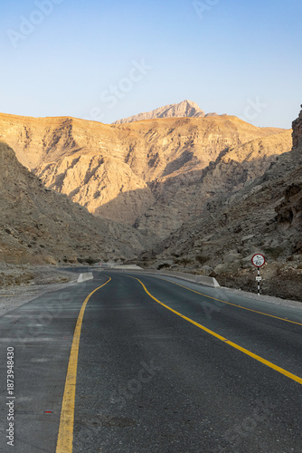 Mountain road background with a stunning view of Jebel Jais under a cloudy sky, a beautiful travel destination in Ras Al Khaimah.