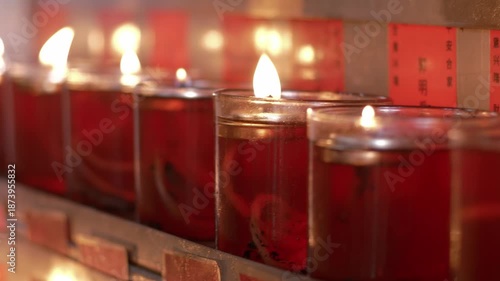 selective focus of Candles for worship lit in a buddhist temple at Jakarta's Chinatown area. translations: That is, the light family