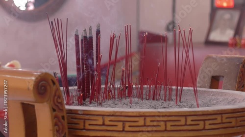 Close-up of hand put Burning Incense Sticks in a Buddhist Temple