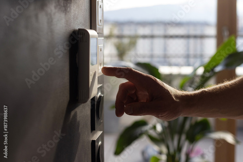 Cuadro en lienzo smart home or home automation, Hand adjusting temperature on thermostat, tempera