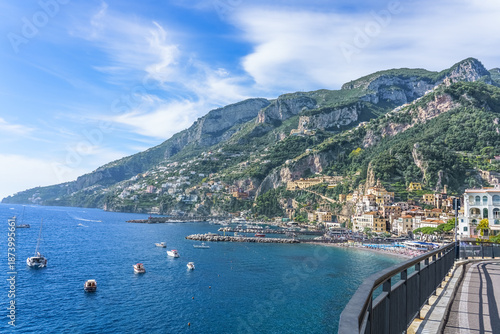 Amalfi, Italy. Scenic view of Amalfi Coast with colorful buildings, clear blue water, and lush green mountains, showcasing the beauty of Italy's coastline