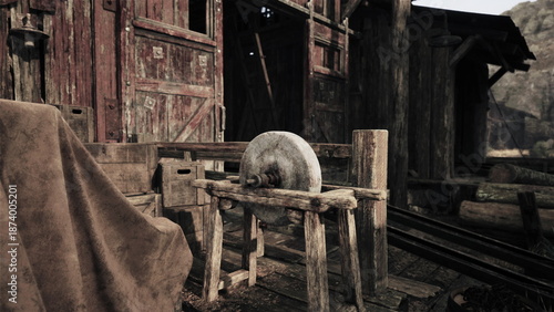 Photos An ancient stone wheel rests on a wooden stand in a quaint workshop