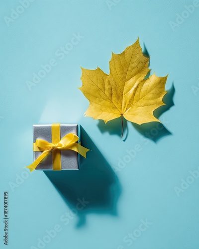 Gift Box And Autumn Leaf On Blue Background
