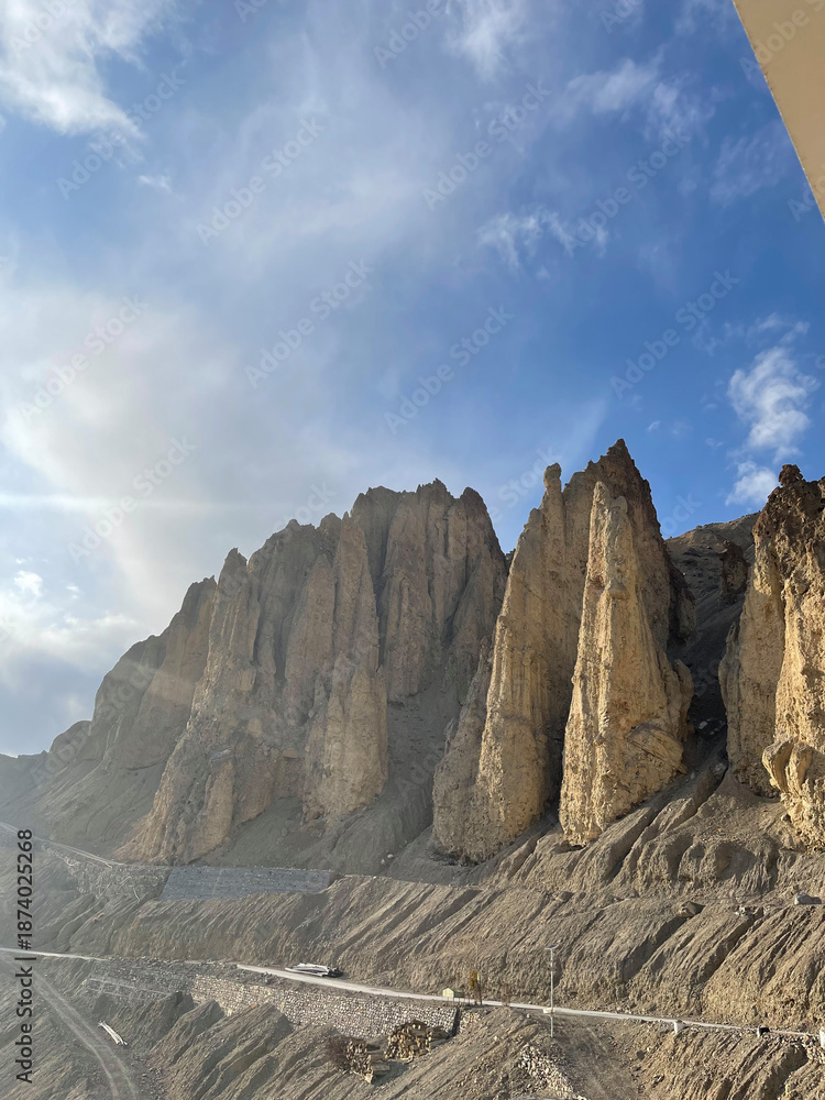 Fototapeta premium Majestic mountain landscape under the blue sky with rocky formations in a remote area