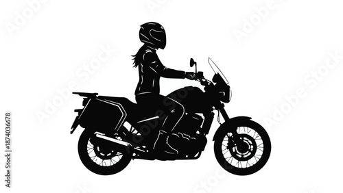 Silhouette of female motorcyclist riding an adventure touring bike