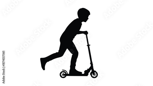 Boy riding a kick scooter in silhouette, playing and having fun