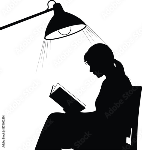 Silhouette of a focused woman intensely reading an open book while sitting directly beneath the direct focused illumination of an adjustable desk lamp against a stark white background