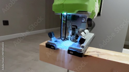 Wallpaper Mural Electric jigsaw cutting wooden board indoors, jigsaw in focus, jigsaw driving through plank with bright sawdust spray, jigsaw shot perfect for diy renovation, woodworking tutorials Torontodigital.ca