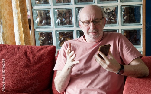 Senior man struggling with modern smartphone technology