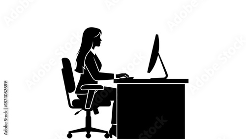 A woman sitting at a desk working on a computer in a modern office