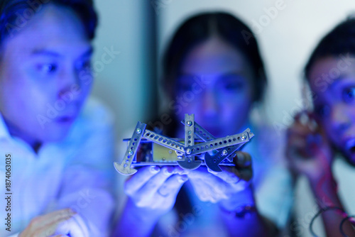 Obraz na płótnie Engineering students testing robotic hand prototype with electronic tools